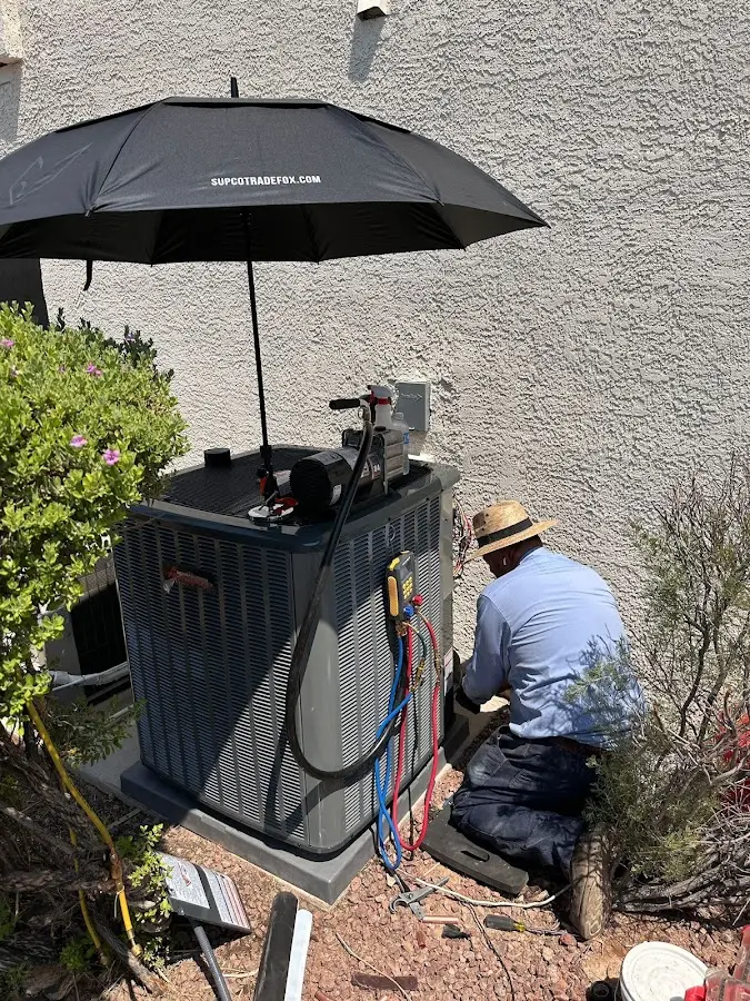 HVAC technician performing outdoor AC maintenance in Rancho Calaveras